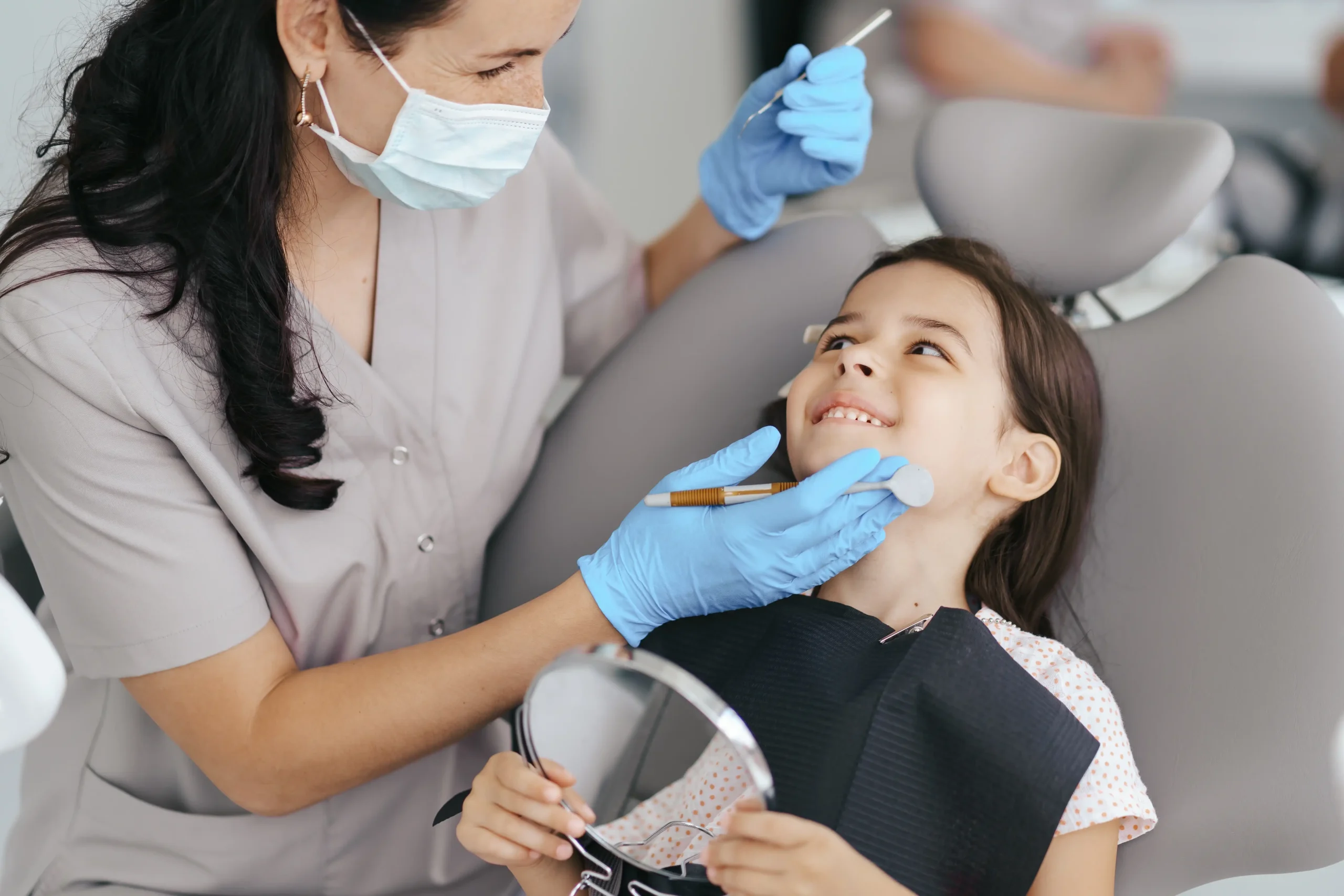 little-beautiful-girl-dentist-smiling_compressed